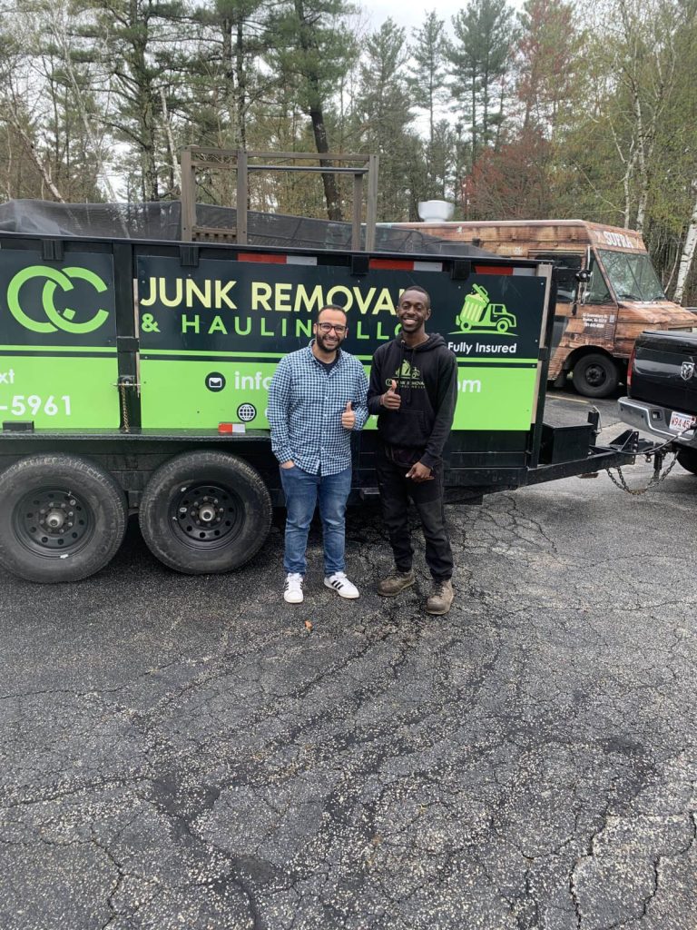 A two men standing in front of a truck with a company name "CC Junk Removal and Hauling"